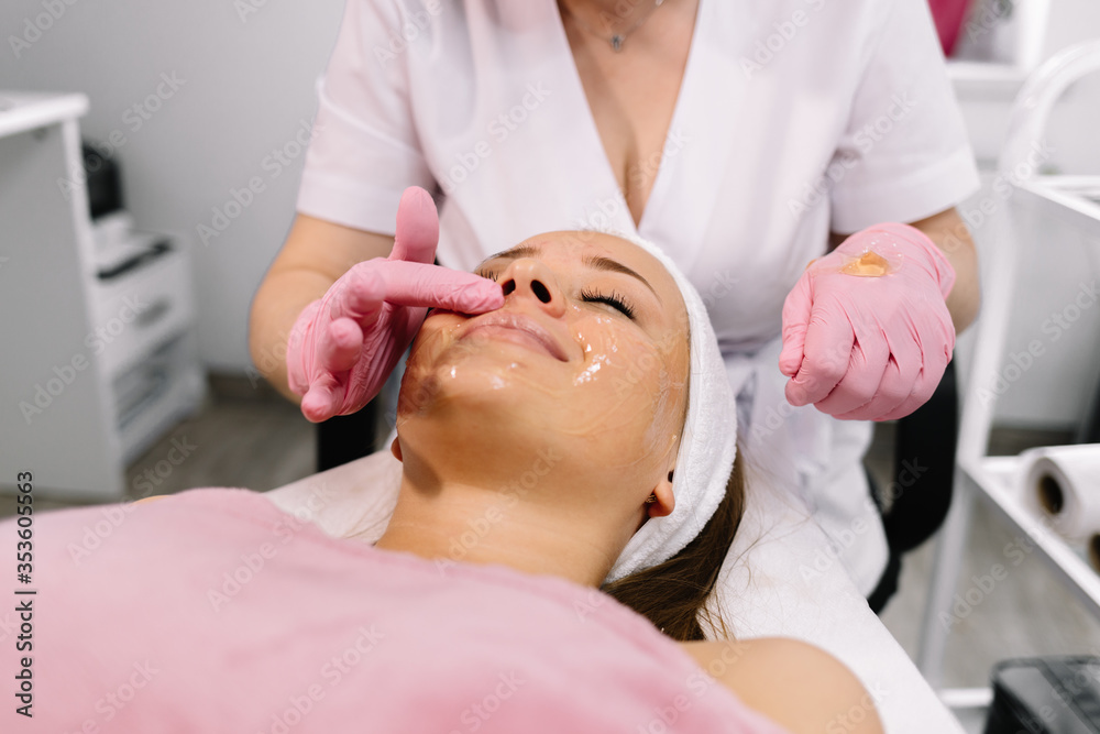 young beautiful woman with facial mask, spa treatment