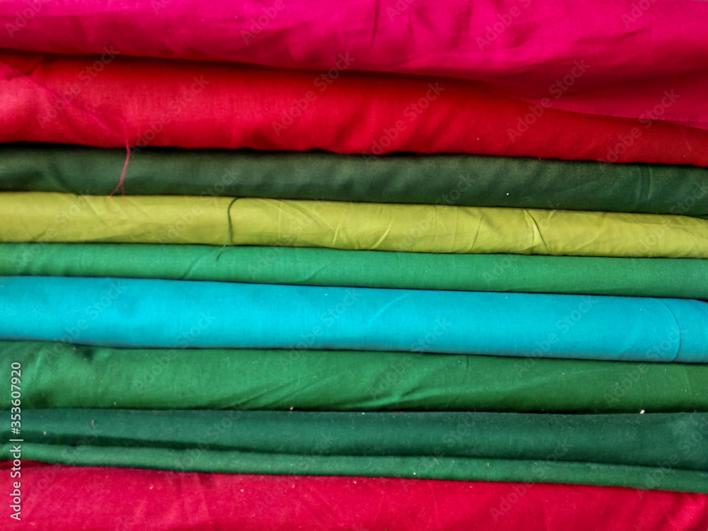 Lots red, green, blue, yellow, pink and other clothes for sewed
