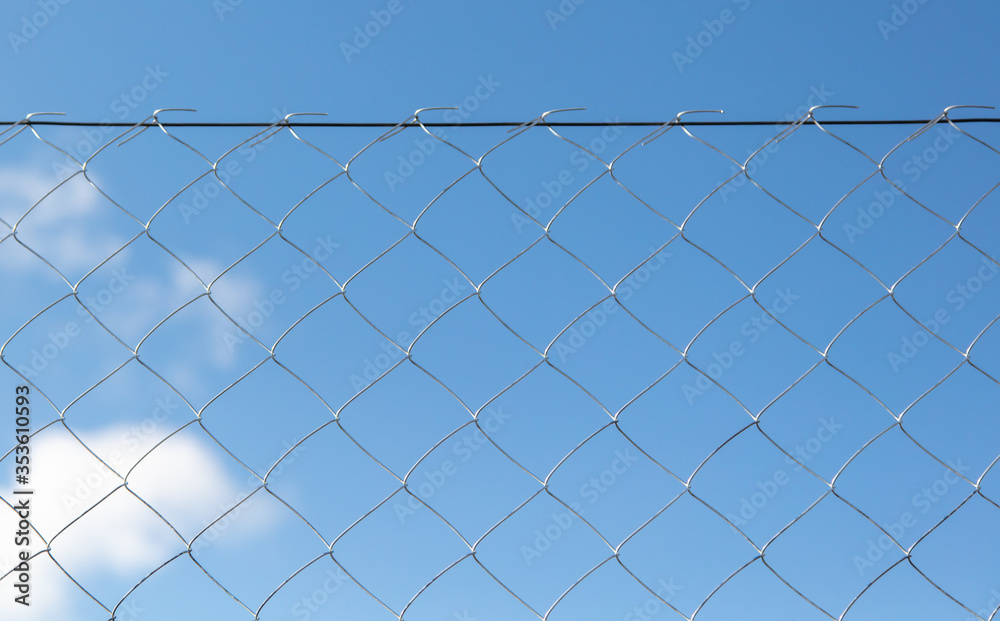 Metal mesh on the fence against the sky. Metal mesh on the fence against the sky.