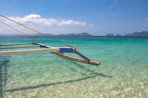 Beautiful beach in the Philippines with blue sky, clouds and a ship