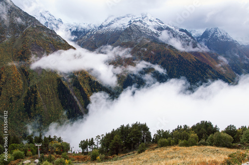 Fog in the mountains, scenic view from the Mount Mussa Achitara in Dombay ski resort in autumn season, Caucasus, Russia photo