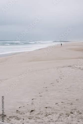 Beautiful empty moody shore of Atlantic ocean with turquoise waves and white sand