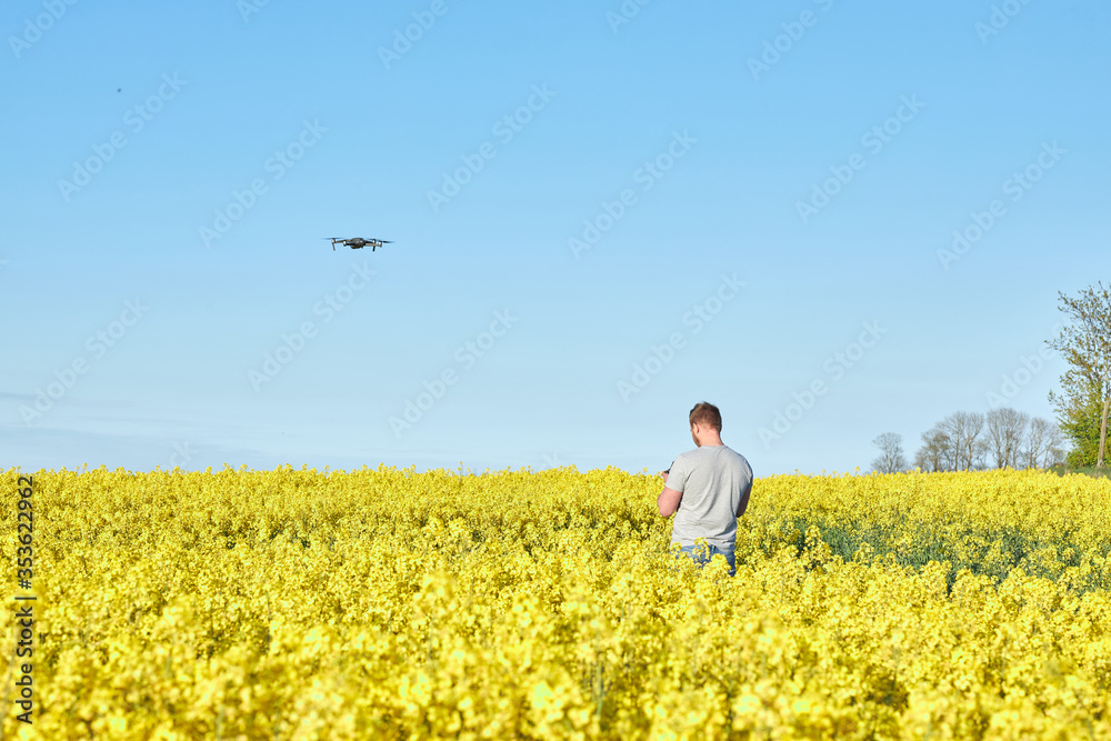 young man in a field pilot drone