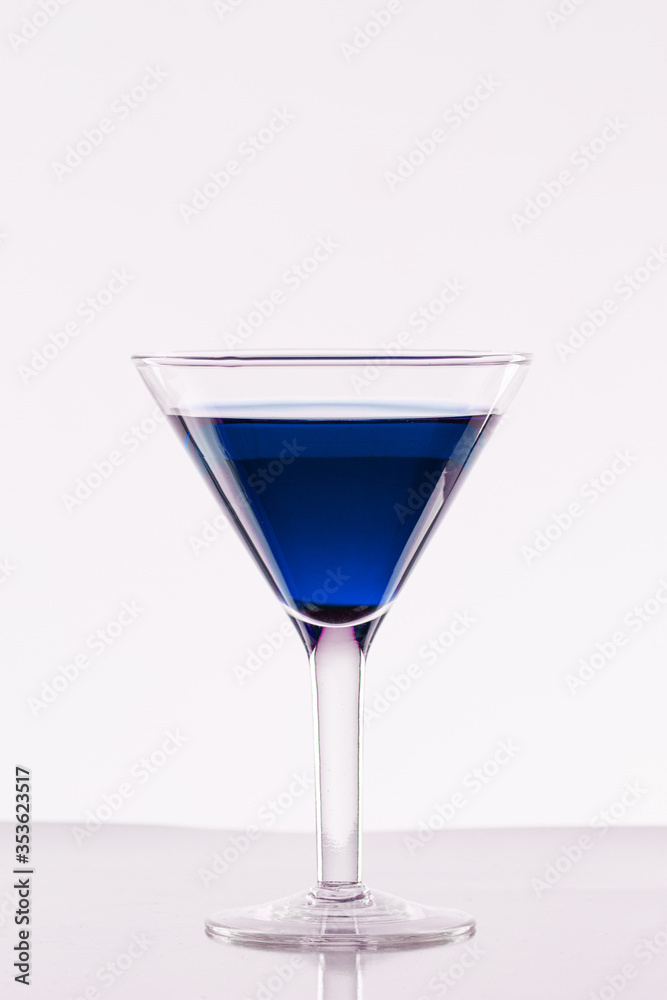 Glass of blue martini on a white background Glass of blue martini on a white background