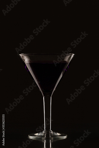 Glass of martini on a black background