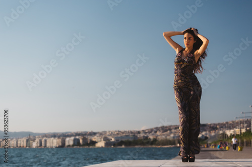 Girl in a long dress on the background of the promenade © olgalisa88