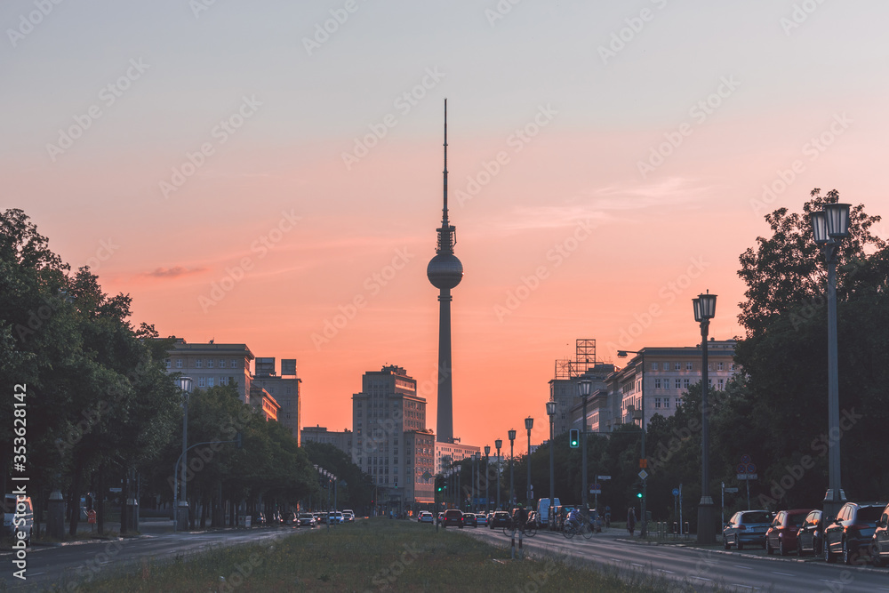 Cityscape of Berlin, Germany, at sunset: Fernsehturm (Television tower) at the end of Karl-Marx-Allee in Friedrichshain quarter (Former East Berlin)
