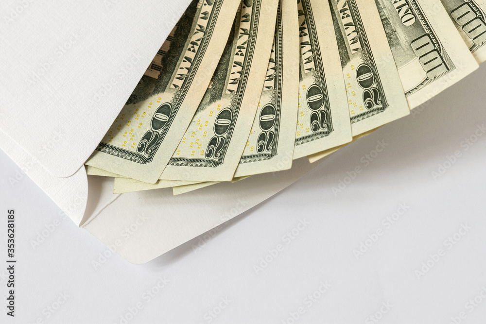 US dollar bills in a white envelope, concept of saving cash, negative interest rates, tax evasion, economic crisis US dollar bills in a white envelope, concept of saving cash, negative interest rates, tax evasion, economic crisis