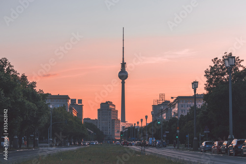 Cityscape of Berlin, Germany, at sunset: Fernsehturm (Television tower) at the end of Karl-Marx-Allee in Friedrichshain quarter (Former East Berlin) photo