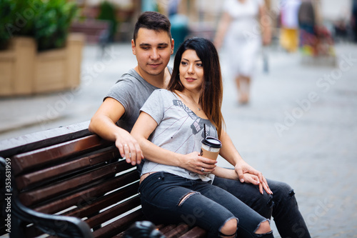 couple posing on the streets of a European city in summer weather.