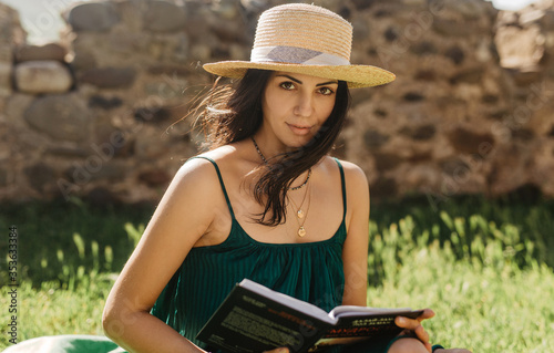 Tableau sur toile young woman reading a book outdoor