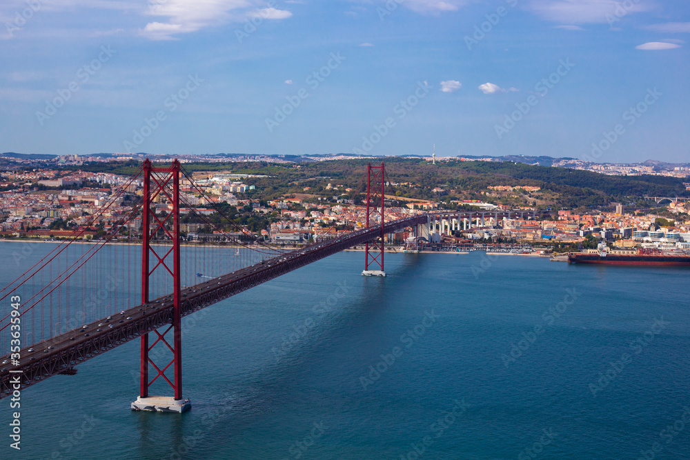 Naklejka premium Ponte 25 de Abril is a suspension bridge connecting the city of Lisbon, to the Almada