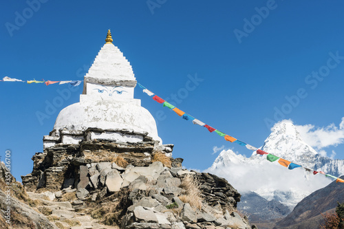 Old white stupa and prayer flags near Pangboche with Ama Dablam in the background, Everest Base Camp trek, Sagarmatha National Park, Nepal