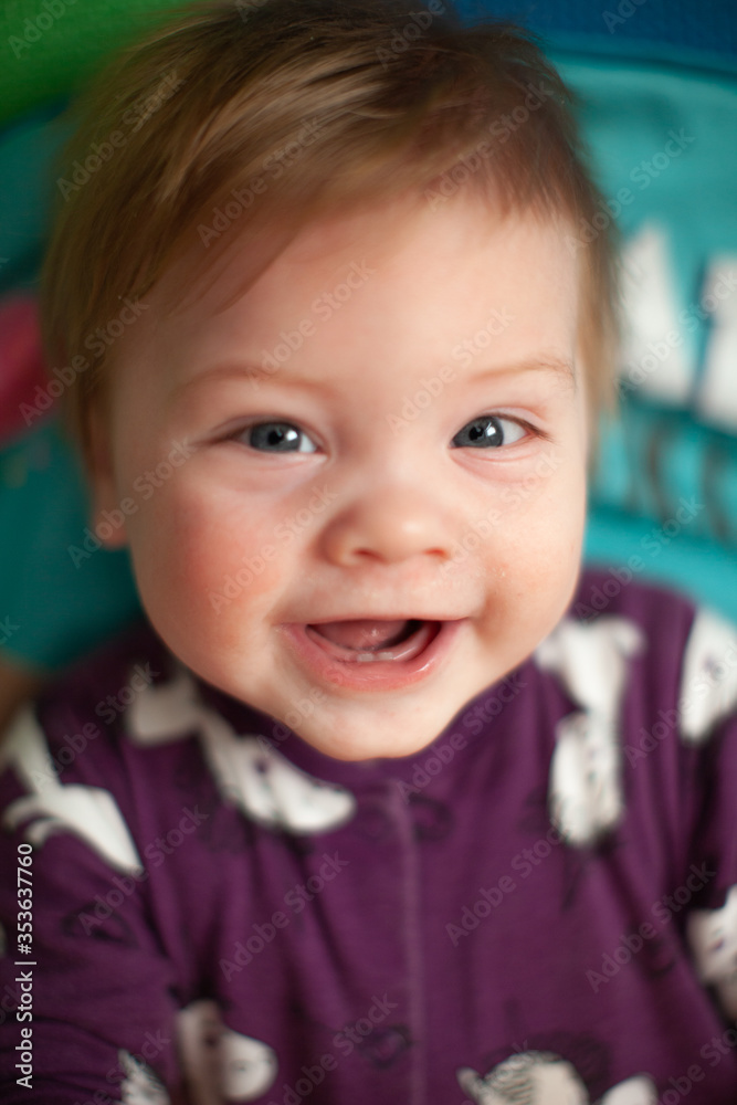 infant in bed with first teeth smiling infant in bed with first teeth smiling