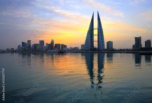 MANAMA, BAHRAIN - FEBRUARY 23: The Bahrain World Trade Center during sunrise, a twin tower complex is the first skyscraper in the world to have wind turbines, February 23, 2018, Manama, Bahrain