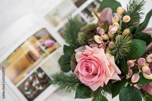 Rose and spruce branch in a vase  magazine on the table