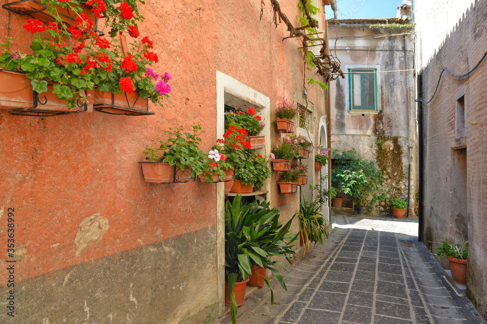 A narrow street among the old houses of an ancient Italian town