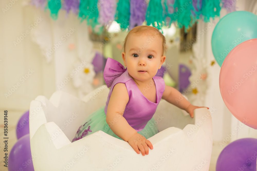 Little girl at purple dress. first birthday
