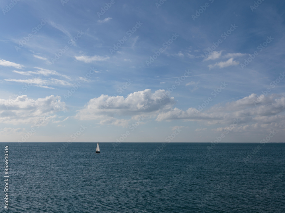 Sailing Yatch in the distance from Brighton Palace Pier, Brighton, England