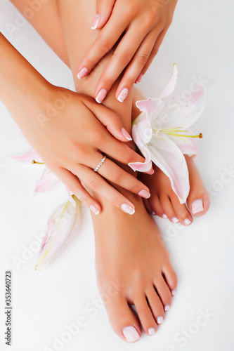 manicure pedicure with flower lily closeup isolated on white background perfect shape hands spa salon