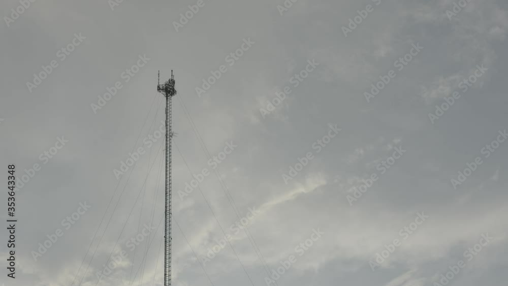 Tethered communication tower on cloudy sunset sky shot in blackmagic 6k raw Tethered communication tower on cloudy sunset sky shot in blackmagic 6k raw