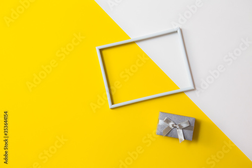 Empty photo frame for text on geometric paper white and yellow colorful background.