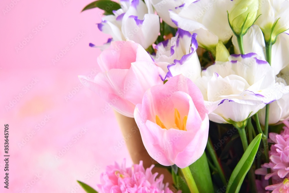 Beautiful elegant spring bouquet for greeting on pink background, selective focus, copy space. Bunch of tender tulips, eustoma flowers and hyacinthus. Romantic bouquet of flowers. Mother’s Day