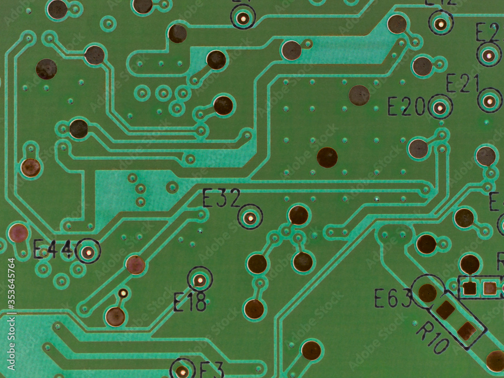 Green printed circuit board PCB hard drive. Fragment of printed wiring board PWB close up. Conductive pattern. IT&C. Background or wallpaper for theme computer hardware. Inverted image. Strong macro Green printed circuit board PCB hard drive. Fragment of printed wiring board PWB close up. Conductive pattern. IT&C. Background or wallpaper for theme computer hardware. Inverted image. Strong macro