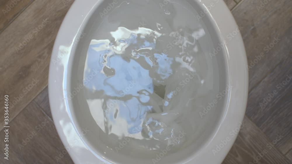 Close up clogging of the toilet. The water flows into the toilet but does not go away. Toilet paper causes clogging. Plumbing in need of repair. Top view Close up clogging of the toilet. The water flows into the toilet but does not go away. Toilet paper causes clogging. Plumbing in need of repair. Top view