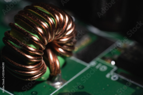 Close up of a computer motherboard copper coil, electrical component