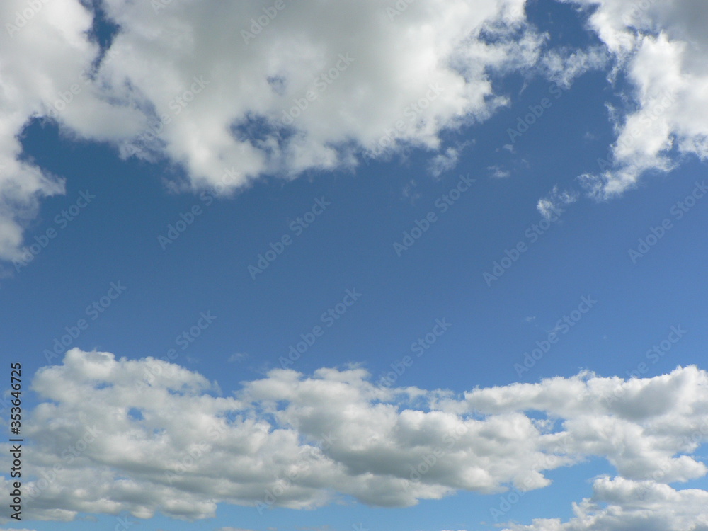 Obraz premium Beautiful blue sky with clouds background. Sky clouds. Air and fluffy clouds in the blue sky on a sunny day, background texture. Copy space. The concept of hope.