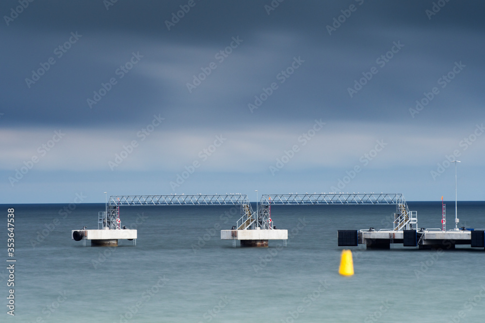 Harbor pier with cloudy sky on background