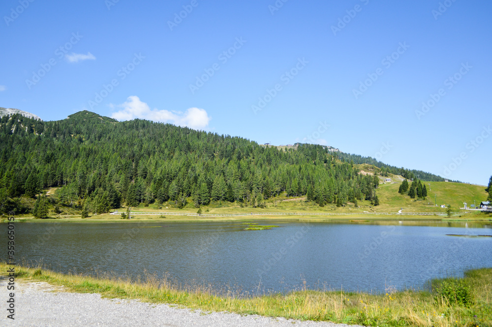 Panoramic view of the Julian Alps in summer, seen from passo Pramollo on the border between Italy and Austria. Mountain Landscape. Panoramic view of the Julian Alps in summer, seen from passo Pramollo on the border between Italy and Austria. Mountain Landscape.
