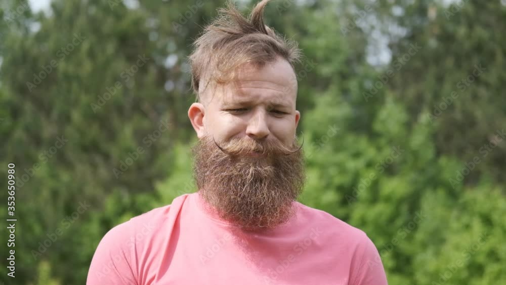 portrait of a man in woods with butterfly, hipster in a pink t-shirt, Sunny summer weather, butterfly on his face, good mood, funny moment portrait of a man in woods with butterfly, hipster in a pink t-shirt, Sunny summer weather, butterfly on his face, good mood, funny moment