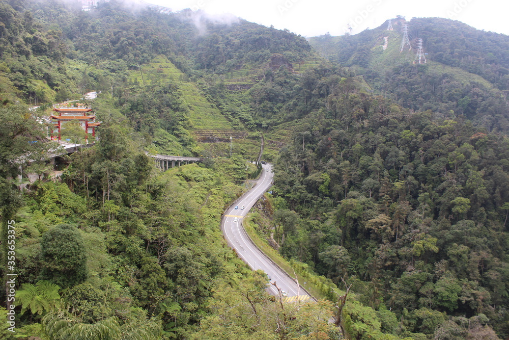 Road in the middle of lush green mountains Road in the middle of lush green mountains