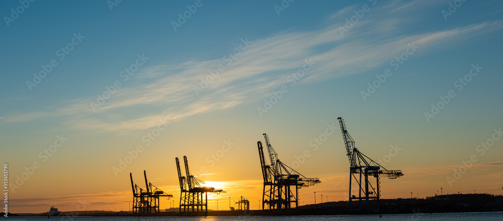 Ship to shore container cranes at sunset