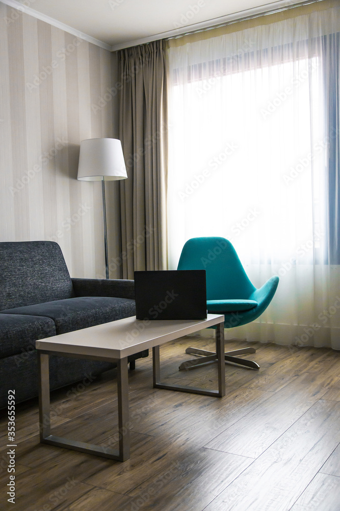 Fototapeta premium Modern house with a black laptop on the table