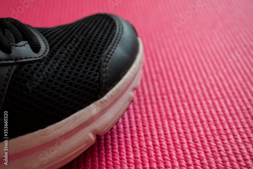 Close-up of workout sneaker on pink background. Workout at home during 2020 self-isolation/quorantine