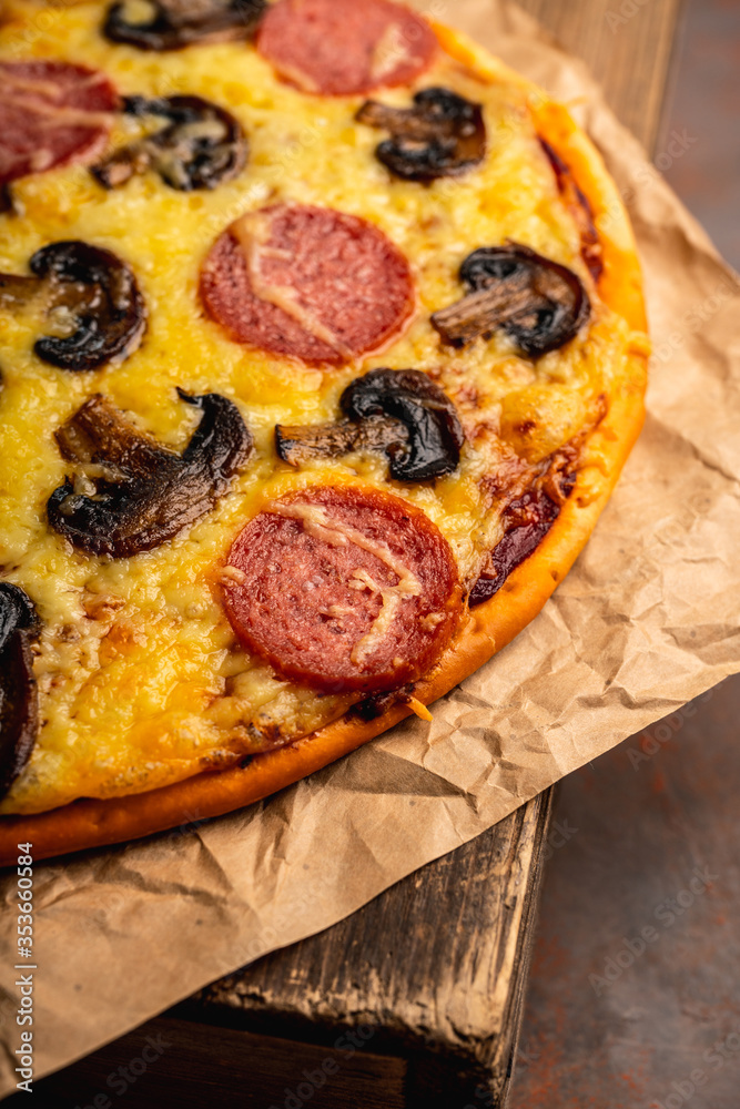 Freshly making pizza with mushrooms served on the rustic background. Selective focus. Shallow depth of field. Freshly making pizza with mushrooms served on the rustic background. Selective focus. Shallow depth of field.