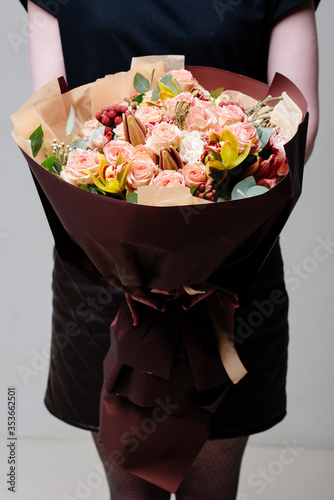 Fototapeta Naklejka Na Ścianę i Meble -  Bouquet of flowers in burgundy package