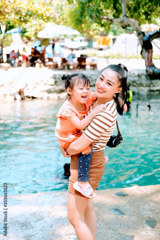 Fototapeta premium happy family having fun on the blue lagoon Vangvieng Lao pdr