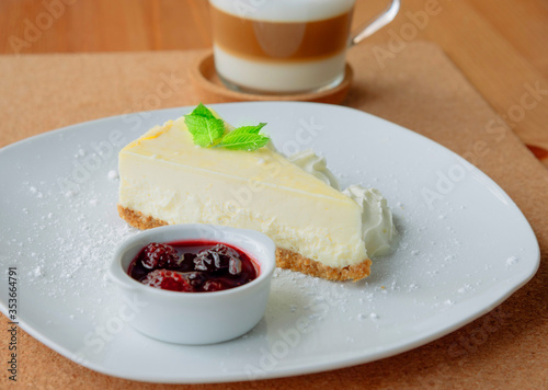 Slice of cheesecake on a plate and cappuccino