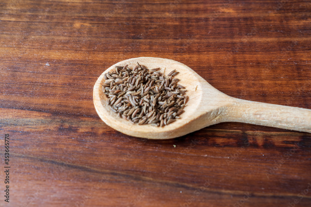 dried cumin seed or caraway in wooden spoon isolated on white background dried cumin seed or caraway in wooden spoon isolated on white background