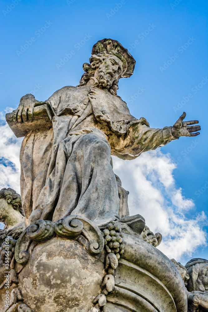Statue of Ivo of Kermartin, an outdoor sculpture by Matthias Braun on the south side of Charles Bridge over the river Vltava in Prague, Czech Republic