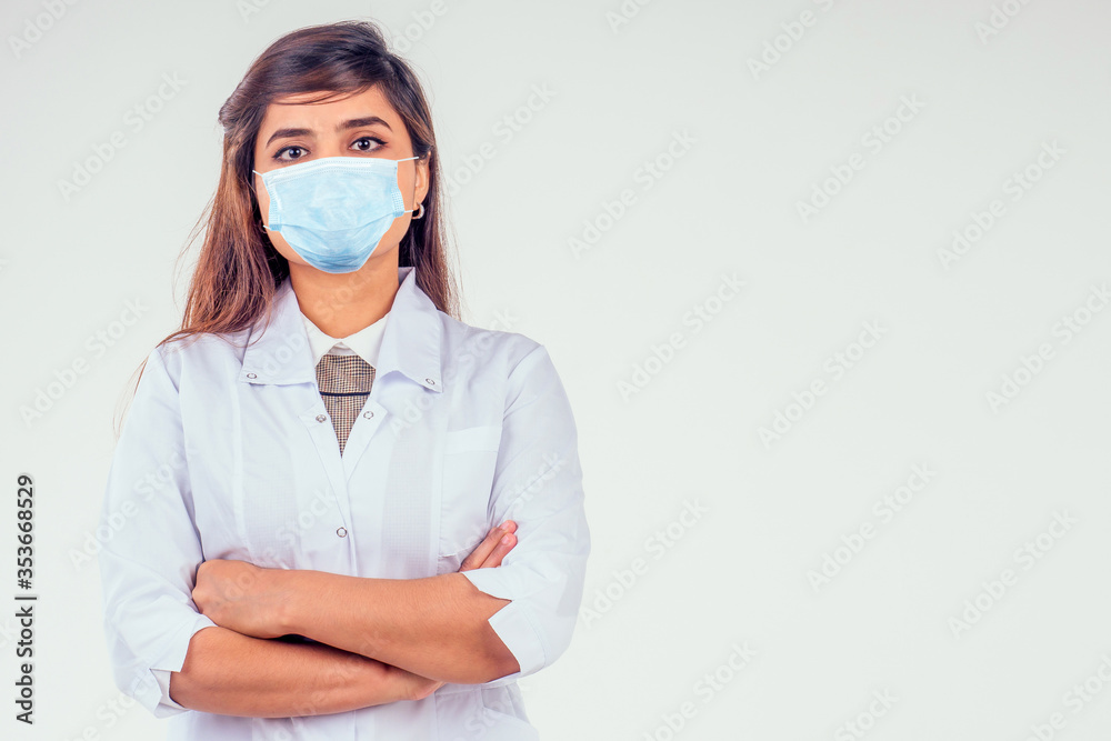 handsome turkey woman surgeon doctor wearing white blazer coat arms crossed on the chest and looking at camera in studio background handsome turkey woman surgeon doctor wearing white blazer coat arms crossed on the chest and looking at camera in studio background