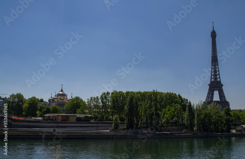 view of the river Seine and the Eiffel Tower with a church in Paris