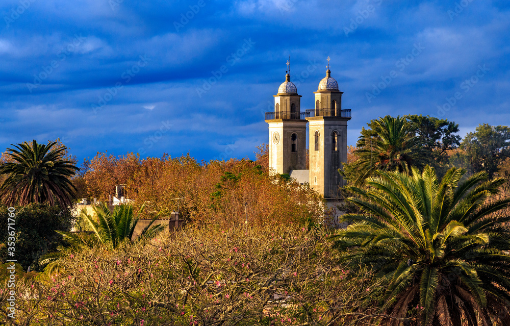 Title: Colonia Del Sacramento church, with two towers with clock.