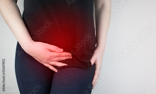 A woman suffers from pain in the pelvic organs. The gynecologist examines the patient. Painful location, female disease, cystitis, or urinary incontinence