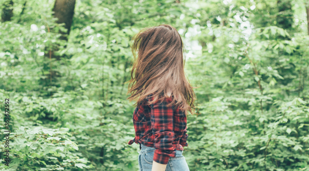 Portrait of a girl on the background of the forest,Girl's hair fly apart Portrait of a girl on the background of the forest,Girl's hair fly apart
