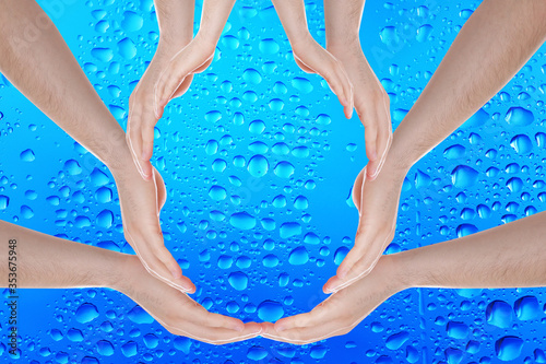 Men forming water drop with their hands on blue background. Ecology protection